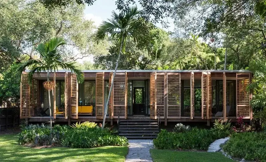 Wooden shutters open to reveal Downtown Miami Brillhart House